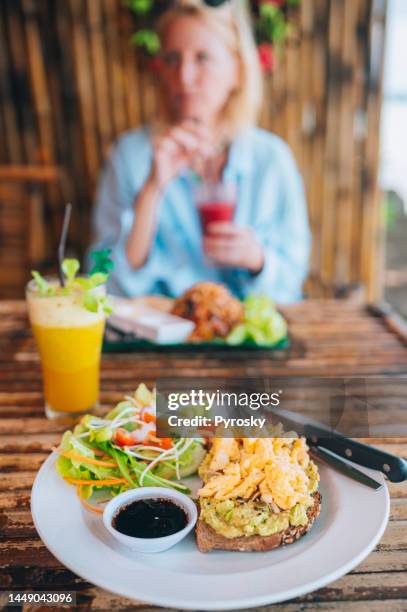 smashed avocado toast-tropical breakfast. - crunchy salad stock pictures, royalty-free photos & images