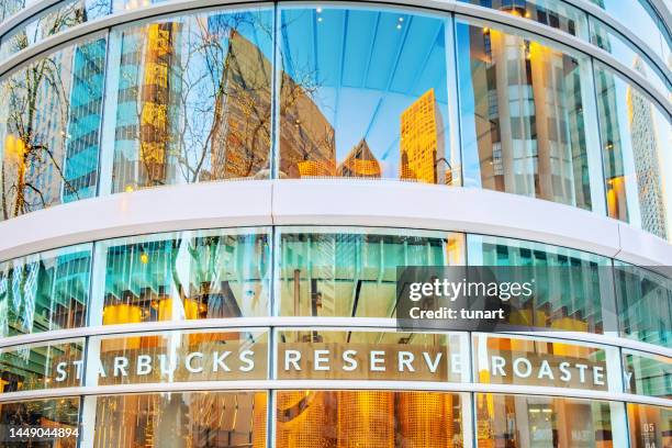 reflections on the outside of the building of starbucks reserve on michigan avenue, chicago, illinois, usa - bright chicago city lights stock pictures, royalty-free photos & images