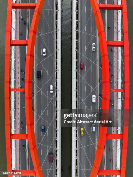 aerial image looking down on vehicles crossing a road bridge, ho chi minh city, vietnam - modern vietnam stockfoto's en -beelden