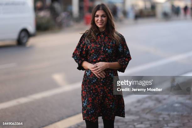 Anna Wolfers seen wearing a red and blue flower printed dress and black tights on December 09, 2022 in Hamburg, Germany.