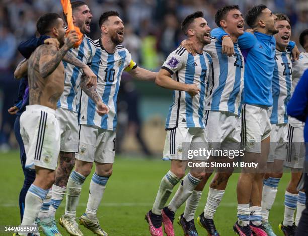 Lionel Messi of Argentina and his teammates celebrate with the fans at full-time during the FIFA World Cup Qatar 2022 semi final match between...