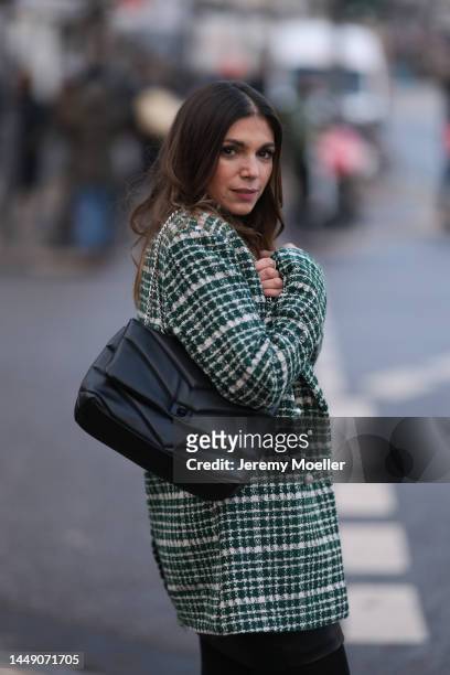 Anna Wolfers seen wearing a green patterned blazer jacket, a black leather mini skirt, dark tights and a black turtle neck sweater on December 09,...