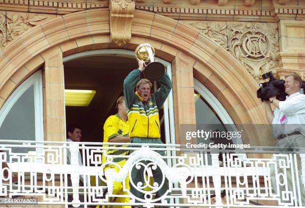 Australia leg spinner Shane Warne celebrates with the trophy on the players balcony after the 1999 ICC Cricket World Cup Final between Australia and...