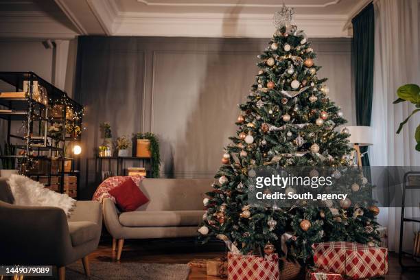 christmas tree and christmas decoration at home - red tinsel stock pictures, royalty-free photos & images