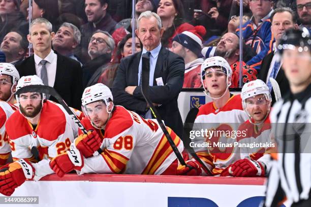 Head coach of the Calgary Flames Darryl Sutter, handles bench duties during the third period against the Montreal Canadiens at Centre Bell on...