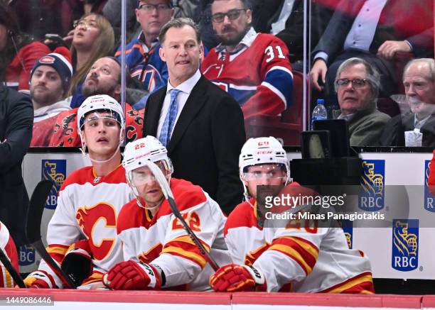 Associate coach for the Calgary Flames Kirk Muller, works the bench during the third period against the Montreal Canadiens at Centre Bell on December...