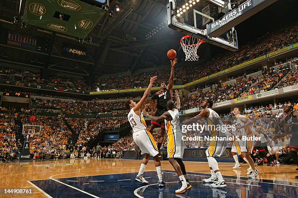 LeBron James of the Miami Heat shoots over Danny Granger, Darren Collison and Roy Hibbert of the Indiana Pacers in Game Four of the Eastern...