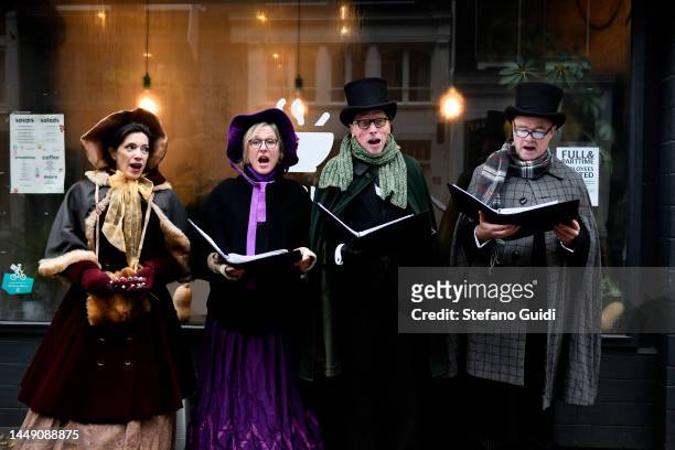 People in early 1900s clothing sing Christmas songs on Jordaan District on December 10, 2022 in Amsterdam, Netherlands. Jordaan is a district of the...