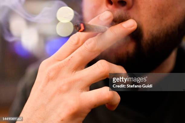 Man smoke a Marijuana cigarette inside the Coffeeshop on Red Light Districton December 10, 2022 in Amsterdam, Netherlands.De Wallen, Amsterdam's...