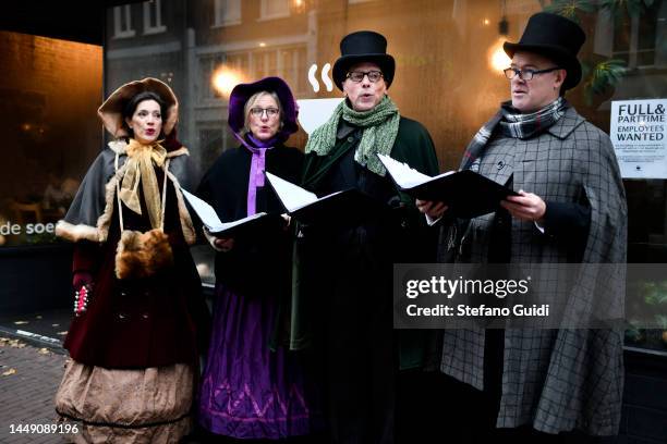 People in early 1900s clothing sing Christmas songs on Jordaan District on December 10, 2022 in Amsterdam, Netherlands. Jordaan is a district of the...