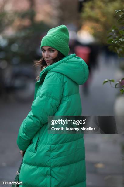 Anna Wolfers seen wearing a green patterned long dress, a green long down coat, a matching green beanie, a green bag on December 09, 2022 in Hamburg,...