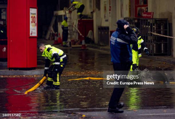Firefighters evacuate a pool of water from a gas station, at Avenida de la Ciudad de Barcelona, on 14 December, 2022 in Madrid, Spain. The...