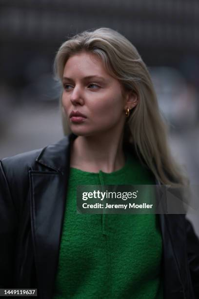 Vivien Sterk seen wearing black leather blazer jacket, green cropped knit pullover and gold earrings on December 09, 2022 in Hamburg, Germany.