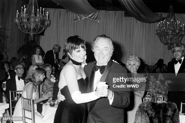 Liza Minnelli dances with Jack Haley Sr. While Rona Barrett watches duringa party at Art Loboe's in Los Angeles, celebrating the recent marriage of...