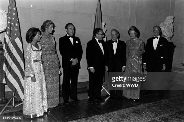 Lise-Marie Sauvagnargues, Nancy Kissinger, Jean Sauvagnargues, Henry Kissinger, guest, Yanne Kosciusko-Morizet, and guest attend a party at the...