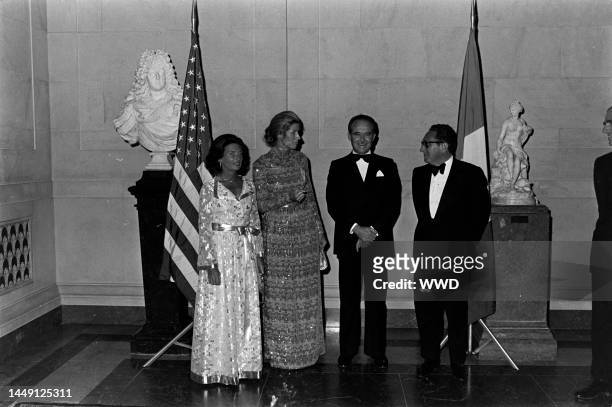 Lise-Marie Sauvagnargues, Nancy Kissinger, Jean Sauvagnargues, and Henry Kissinger attend a party at the National Gallery of Art in Washington, D.C.,...