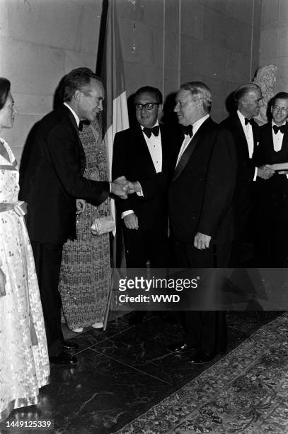 Lise-Marie Sauvagnargues, Jean Sauvagnargues, Henry Kissinger, James Reston, and guests attend a party at the National Gallery of Art in Washington,...