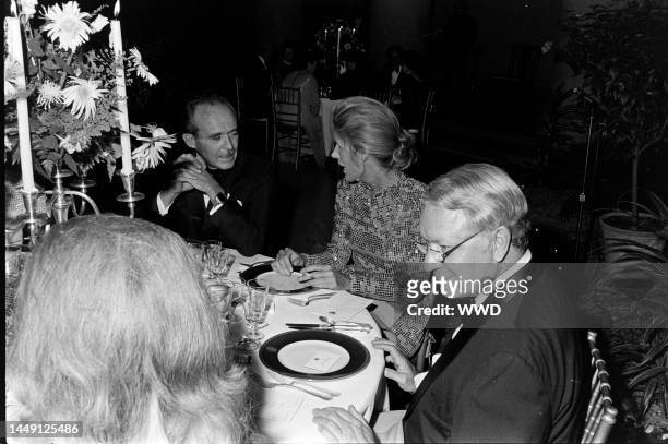 Jean Sauvagnargues, Nancy Kissinger, and James Reston attend a party at the National Gallery of Art in Washington, D.C., on September 27, 1974.