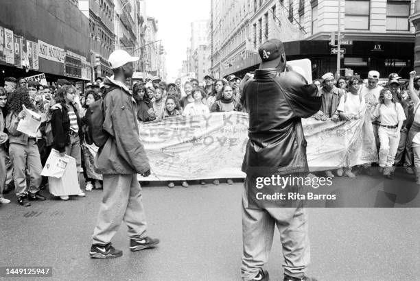 View of marchers, many with signs and others holding a banner, during the demonstration , in SoHo, New York, New York, May 1, 1992. The protest was...