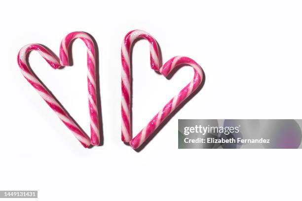 two hearts made with candy canes on a white background - heart candy on white stock-fotos und bilder