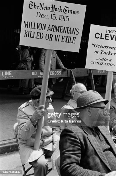 View of attendees at an Armenian Genocide Remembrance Day event, New York, New York, April 1987. One visible sign references a New York Times...