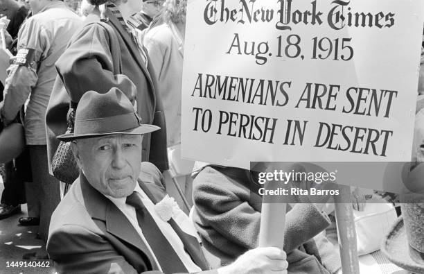 Portrait of an attendee, with a sign, at an Armenian Genocide Remembrance Day event, New York, New York, April 1987. His sign references a New York...