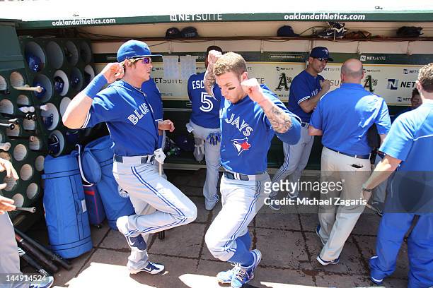 Colby Rasmus and Brett Lawrie of the Toronto Blue Jays go through a pregame ritual in the dugout prior to the game against the Oakland Athletics at...