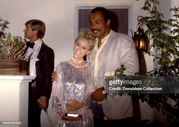 English film and television actress Susan George and American professional boxer Ken Norton Sr. Pose for a portrait, Los Angeles, California, circa...