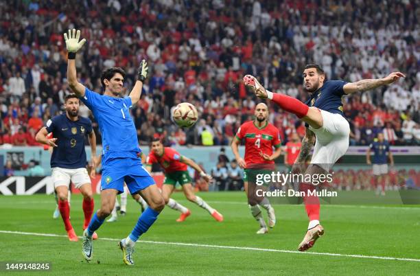 Theo Hernandez of France scores the team's first goal past Yassine Bounou of Morocco during the FIFA World Cup Qatar 2022 semi final match between...