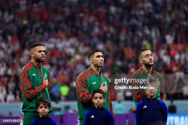 Youssef En-Nesyri, Achraf Hakimi and Hakim Ziyech of Morocco line up for the national anthem prior to the FIFA World Cup Qatar 2022 semi final match...