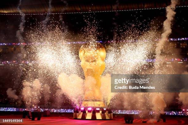 Pyrotechnics explode around a giant FIFA World Cup trophy prior to the FIFA World Cup Qatar 2022 semi final match between France and Morocco at Al...