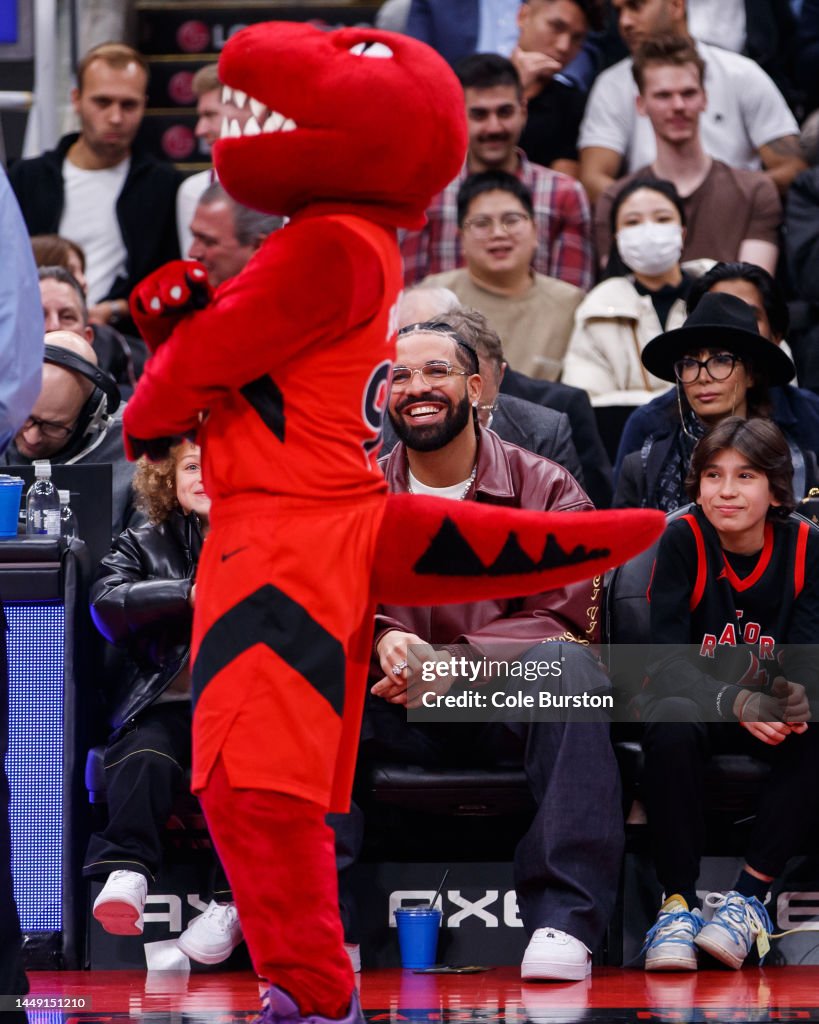 Riverside Raptors Rvc Mascot Rapper Drake and his son Adonis Graham watch as the Raptors mascot ...