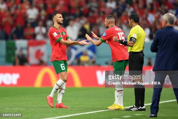 Romain Saiss of Morocco is substituted by Selim Amallah during the FIFA World Cup Qatar 2022 semi final match between France and Morocco at Al Bayt...