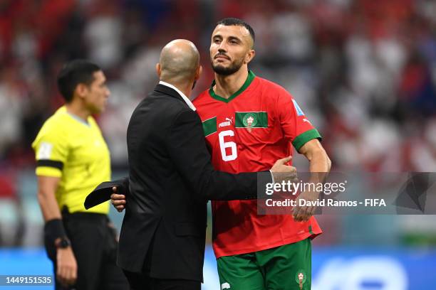 Romain Saiss of Morocco is consoled by Walid Regragui, Head Coach of Morocco, after being substituted during the FIFA World Cup Qatar 2022 semi final...