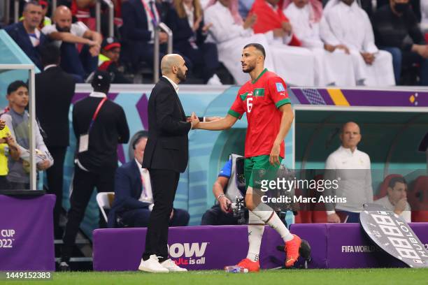 Hoalid Regragui, Manager of Morocco greets Romain Saiss of Morocco as he substituted off due to injury during the FIFA World Cup Qatar 2022 semi...