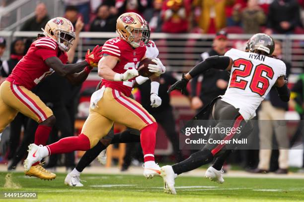 Christian McCaffrey of the San Francisco 49ers runs against Logan Ryan of the Tampa Bay Buccaneers at Levi's Stadium on December 11, 2022 in Santa...