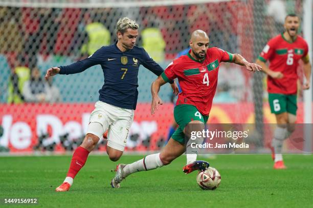 Antoine Griezmann of France fights for the ball with Sofyan Amrabat of Morocco during the FIFA World Cup Qatar 2022 semi final match between France...