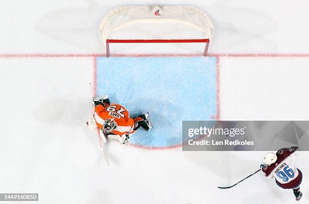 Carter Hart of the Philadelphia Flyers prepares to stop a shot on goal against Mikko Rantanen of the Colorado Avalanche at the Wells Fargo Center on...