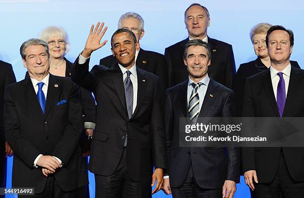 President Barack Obama , waves as he poses for the family photo with Prime Minister of Albania Sali Berisha , NATO Secretary General Anders Fogh...