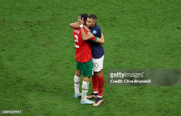 Achraf Hakimi of Morocco embraces Kylian Mbappe of France after the FIFA World Cup Qatar 2022 semi final match between France and Morocco at Al Bayt...