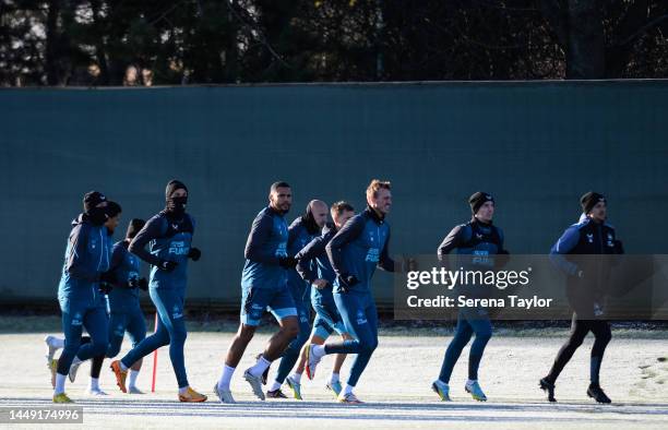 Players warm up with Newcastle United's Sports Scientist Dan Hodges during a Newcastle United Training Session at the Newcastle United Training...