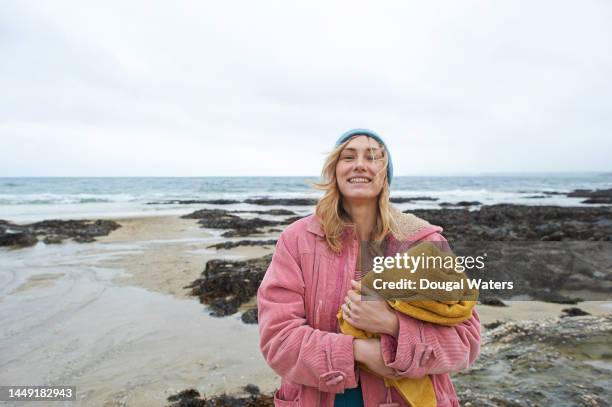 a woman at the beach in winter - winter strand stock-fotos und bilder