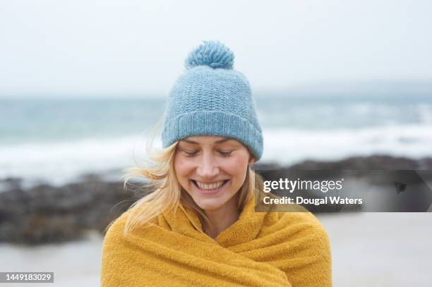 a female swimmer at the coast - healthy lifestyle winter stock pictures, royalty-free photos & images