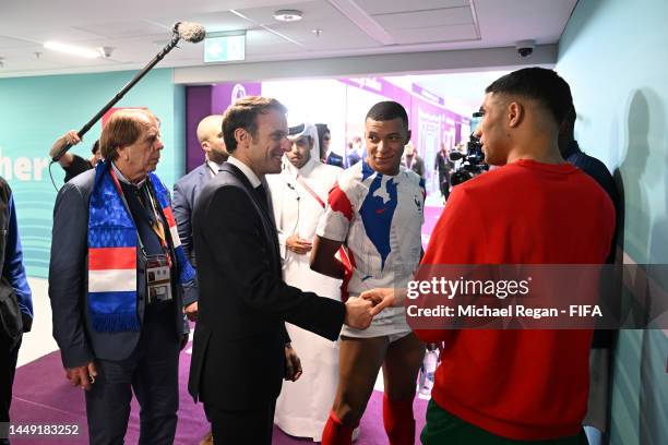 French President Emmanuel Macron interacts with Kylian Mbappe of France and Achraf Hakimi of Morocco in the tunnel after the FIFA World Cup Qatar...