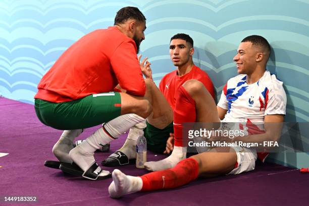 Kylian Mbappe of France interacts with Sofiane Boufal and Achraf Hakimi of Morocco in the tunnel after the FIFA World Cup Qatar 2022 semi final match...