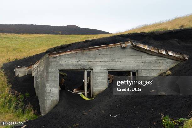 House buried in cinders from eruption of Eldfell cinder cone in 1973, Iceland..