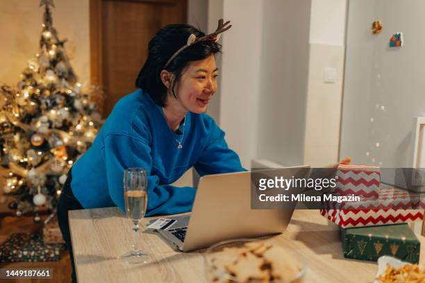 young chinese woman celebrating new year at home alone - chinese year of the dog stock pictures, royalty-free photos & images