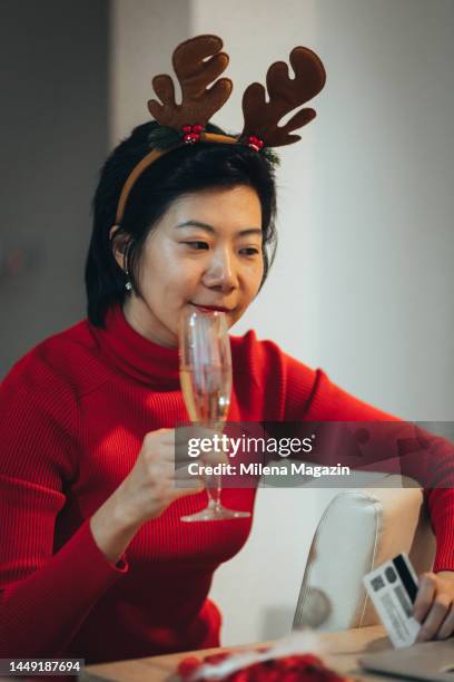 asian woman celebrating chinese new year by shopping online - chinese year of the dog stock pictures, royalty-free photos & images