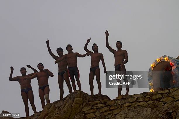 Cliff divers wave before jumping at La Quebrada in Acapulco, Mexico on May 17, 2012. The tradition of 'La Quebrada' goes back to 1934, when two...
