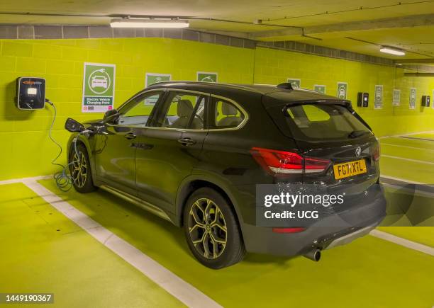 Newbury, Berkshire, England, UK, Electric car battery charging station in an underground car park.